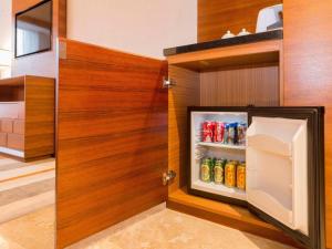 an open refrigerator with drinks in a kitchen at MeiQiu-Fino Hotel in Zhuhai