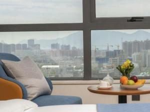 a living room with a table with fruit on it at Kunming Guihua Hotel in Kunming