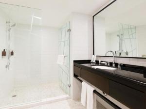 a bathroom with a sink and a shower at Beijing New World Center Tongpai Hotel in Beijing +99 photos