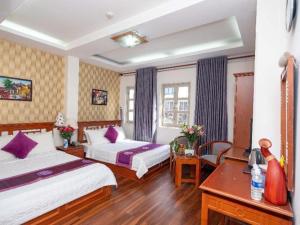 a hotel room with two beds and a desk at Hồng Hạc hotel in Ho Chi Minh City +107 photos