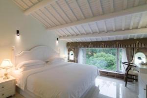 Voodi või voodid majutusasutuse Hangzhou Teavilla Hotel toas +290 fotot