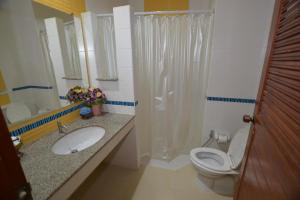 a bathroom with a toilet and a sink and a shower at CK Hills Hotel in Mae Sot +100 photos