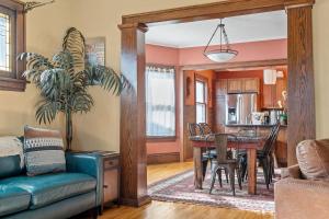 a living room with a table and a dining room at Urban Oasis in Minneapolis