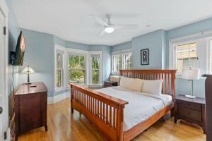 Un dormitorio con una cama con paredes y ventanas azules. en Harriet House, en Minneapolis