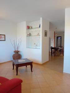 a living room with a red couch and a coffee table at A casa di Sonia in Martano