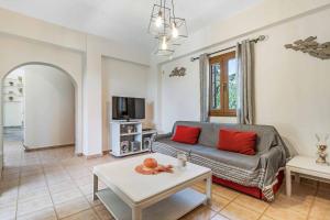a living room with a couch and a table at Villa Petra in Methoni