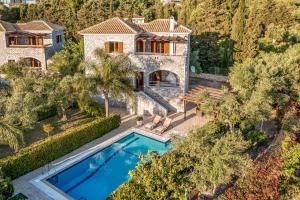 an aerial view of a house with a swimming pool at Villa Petra in Methoni