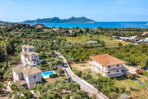 an aerial view of a house with the ocean in the background at Villa Petra in Methoni