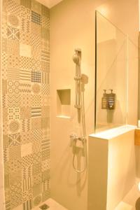 a bathroom with a shower with a glass door at Sunset Paradise Canggu in Canggu