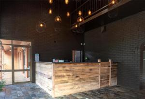 a wooden counter in a room with a brick wall at Nightcap at Archer Hotel in Nowra