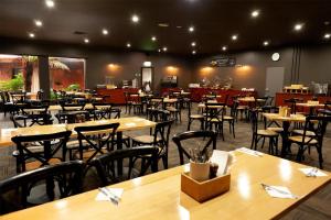 a dining room with tables and chairs in a restaurant at Nightcap at Archer Hotel in Nowra