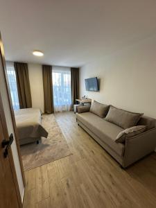 a living room with a couch and a bed at Inn West Hotel by Pysanka in Kolomiya