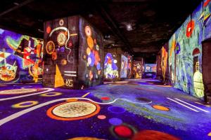 a room with colorful paintings on the walls at Le Cabanon d 'Aix in Aix-en-Provence