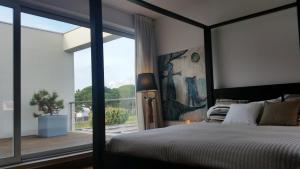 a bedroom with a bed and a large window at Casa da Ribeira in Aldeia do Meco +28 photos