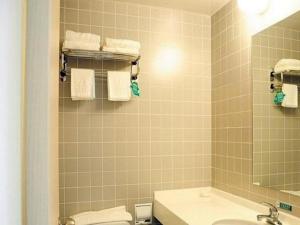 a bathroom with a sink and a toilet and towels at Jinjiang Inn Jinan Daming Lake in Jinan +100 photos