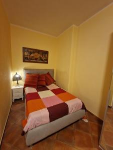 a bedroom with a bed and a lamp on a tiled floor at Villa Colle degli Ulivi con piscina e sguardo sul mare in Cerveteri