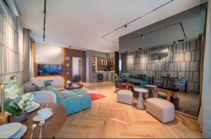 a living room with blue couches and a dining room at Saden Albwadi in Jeddah