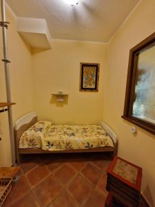 a small bedroom with a bed in a room at Villa Colle degli Ulivi con piscina e sguardo sul mare in Cerveteri +66 photos
