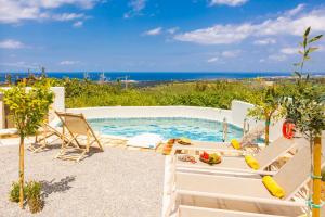 a swimming pool with a view of the ocean at Villa Erofili in Agia Triada