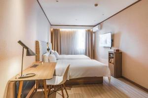 Ένα ή περισσότερα κρεβάτια σε δωμάτιο στο Hi Inn Shanghai Zhongshan Park Branch +153 φωτογραφίες