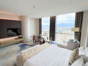 Postel nebo postele na pokoji v ubytování LONGYAN JINGHUA FLIPORT HOTEL + 277 fotografií