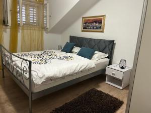 a bedroom with a bed with blue pillows at Apartment Felix in Split