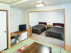 TV a/nebo společenská místnost v ubytování Ichimanri Hotel Golden Century