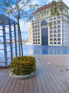 a tree in a planter in front of a building at Netflix Two Bedroom Troika Kota Bharu Homestay 118 in Kota Bharu +35 photos