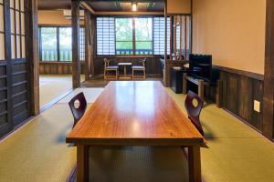 a conference room with a wooden table and chairs at Shinwaen in Aso +127 photos