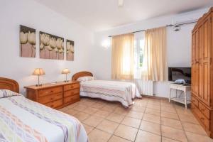Un dormitorio con dos camas y un televisor. en Villa Alaris, en Santo Tomás 38 fotos más