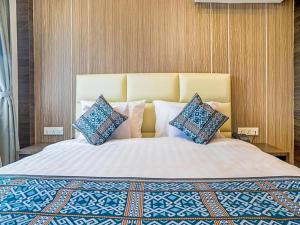 a bedroom with a large bed with pillows on it at Rajawali Homes Kota Marudu in Kampong Tumsun +82 photos