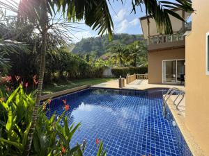 a swimming pool in the backyard of a house at Nai Thon villa with pool, garden, rooftop terrace in Ban Sakhu