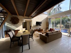 a living room with a couch and a table at Nai Thon villa with pool, garden, rooftop terrace in Ban Sakhu
