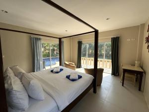 a bedroom with a large bed with a large window at Nai Thon villa with pool, garden, rooftop terrace in Ban Sakhu +19 photos