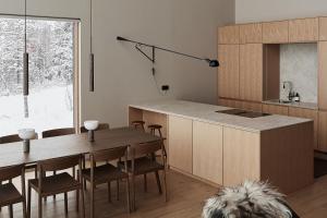 a kitchen and dining room with a table and a dog at Stay North - The House of Northern Lights in Äkäslompolo