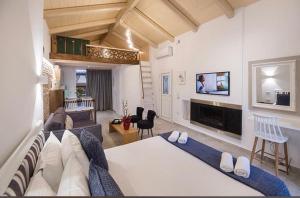 a large living room with a couch and a tv at Carezza Apartments in Preveza