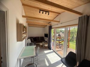 a room with a table and chairs and a patio at Domki Letniskowe Kosewo in Kosewo