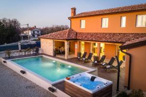 a swimming pool in front of a house at Villa Starlight Gaze in Modrušani
