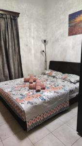 a bed with a quilt on it in a room at Apartman Dionis J in Skála Neón Epivatón