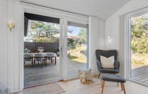 a living room with a chair and a table at Stunning Home In Saltum With Wifi in Saltum