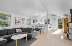 a living room with a couch and tables and a kitchen at Stunning Home In Saltum With Wifi in Saltum