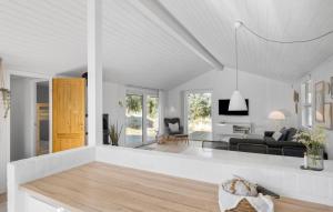 a white living room with a couch and a table at Stunning Home In Saltum With Wifi in Saltum +9 photos