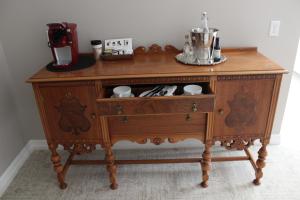 a wooden dresser with a coffee maker on top of it at Erik's Retreat in Edina