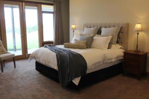 a bedroom with a large bed and a window at Drom Aluinn B & B in Acheron