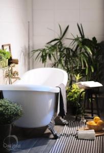 a white bath tub in a bathroom with plants at 2BR House with Bathtub near Old City in Chiang Mai +69 photos