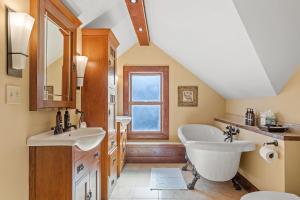 a bathroom with two sinks and a tub and a window at Urban Retreat in Minneapolis
