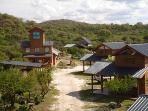a village with a building with a clock tower at Onozone Junior in Capilla del Monte