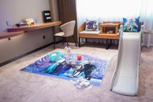 a living room with a table with action figures on it at Riverside International Hotel in Wuzhou