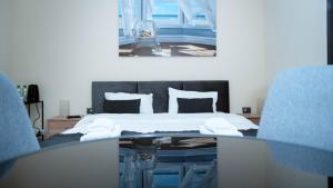 a bedroom with a bed and a table and chairs at SergJuli Villa in Plavecký Štvrtok