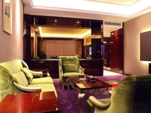 a living room with couches and chairs and a television at Riverside International Hotel in Wuzhou
